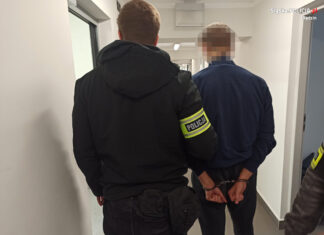 policjant prowadzi aresztowanego